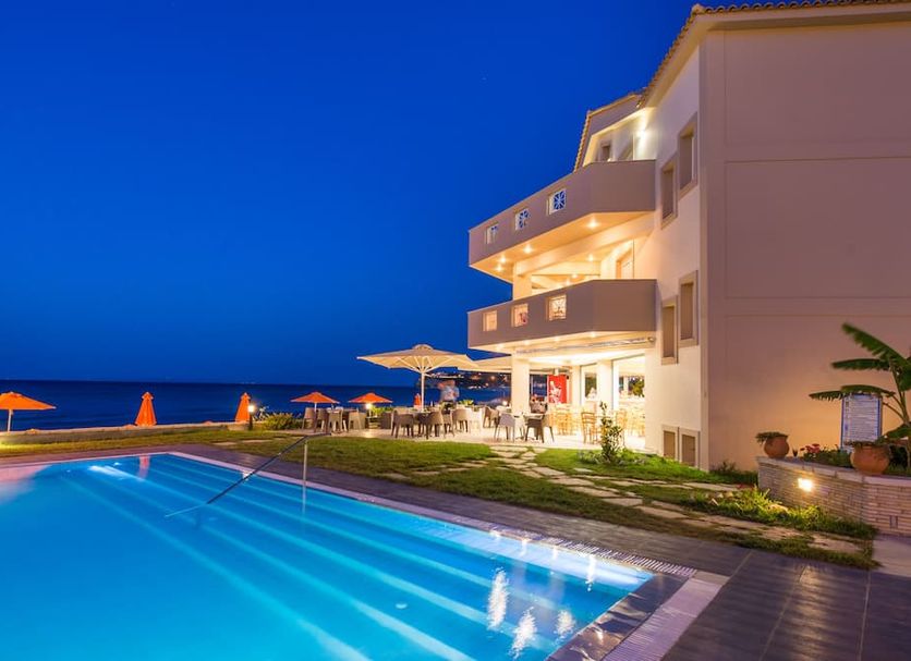 Al Mare Hotel in Tsilivi with illuminated outdoor pool beside the sea at dusk