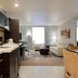 Home2 Suites by Hilton Anchorage/Midtown suite with kitchenette, desk, sofa, and chair in Anchorage