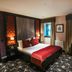 The Torrance Hotel, Glasgow guest room with king bed, patterned carpet, and bathroom view