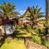 Hotel Vai Moana in Hanga Roa with tropical bungalows, palm trees, and an A-frame lodge