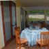 Real Asturias Hotel in Acquappesa terrace dining area with round table, chairs, and outdoor hillside view
