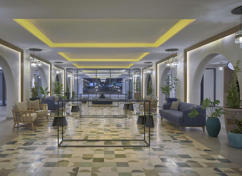 Hilton Skanes Monastir Beach Resort lobby with modern seating, arched hallways and ocean view in Monastir