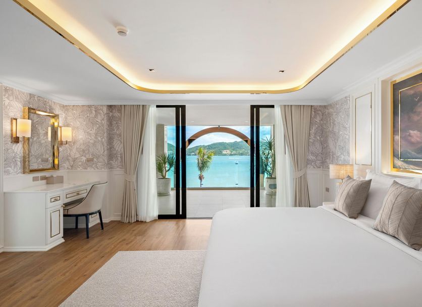 The Cyan at Patong Hotel in Patong suite with king bed and ocean view through balcony doors
