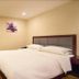Chengdu Tianfu Lidu Hotel room with king bed, wood flooring, and beige walls in Chengdu