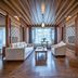 Lijiang Tianyu Boutique Hotel in Lijiang: spacious guest room with wood ceiling, sofa seating, and twin beds
