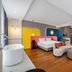 Yiting Huicheng Hotel Xiamen in Xiamen, colorful guest room with freestanding tub and modern seating