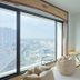 The Royal City Hotel Bangkok room with floor-to-ceiling window and city skyline view