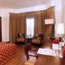 The Retreat Hotel & Convention Centre Mumbai room with bed, seating area and window curtains