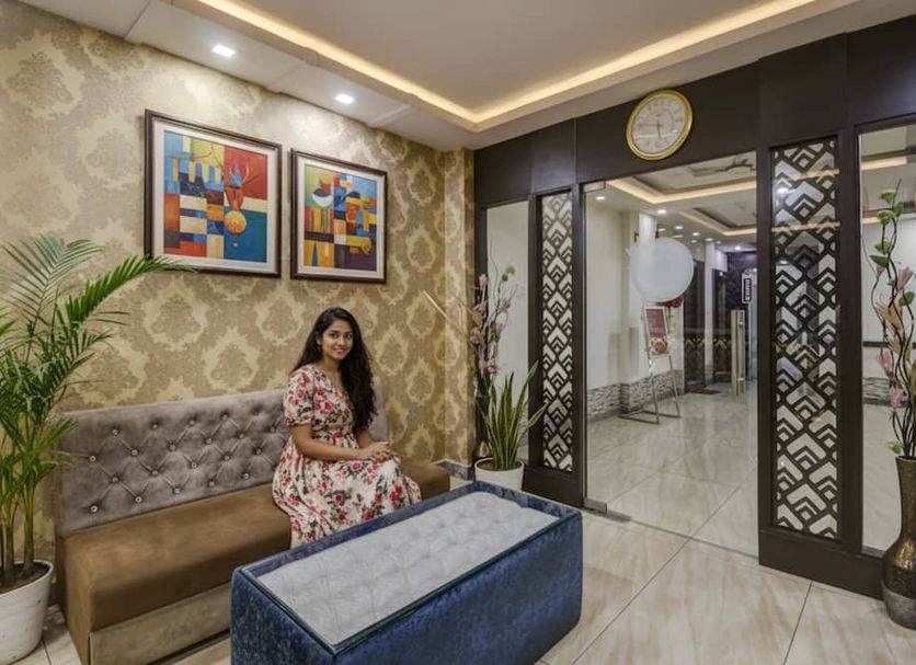 Hotel O Csfc in Bhopal lobby with tufted sofa, patterned walls, framed art and glass entry doors