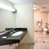 Red Carpet Inn - New Brunswick bathroom with vanity, sink, toilet, grab bar, and tiled floor