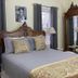 Lightner Farmhouse B&B Gettysburg bedroom with carved wood bed, armoire, nightstands and window views