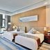 Wonderland Hotel Luxury, Hangzhou guest room with twin beds and floor-to-ceiling windows overlooking greenery