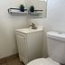 Budget Inn and Suites El Centro bathroom with toilet, sink vanity, mirror and tile floor