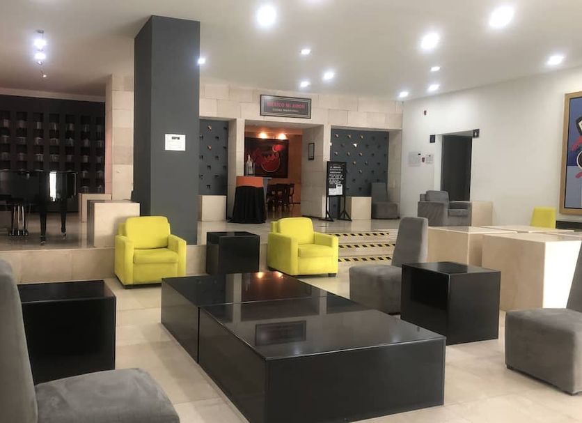 We Hotel Aeropuerto Mexico City lobby with modern seating and piano