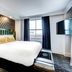 The Warrior Hotel, Autograph Collection in Sioux City room with king bed, window view and wall-mounted TV
