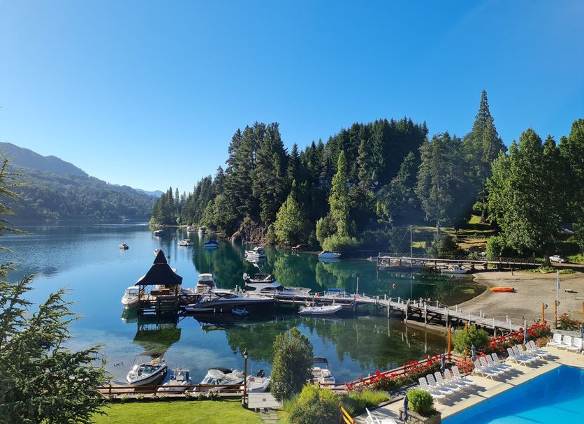 Bahia Manzano Resort in Villa La Angostura with lakefront dock, boats, and mountain views