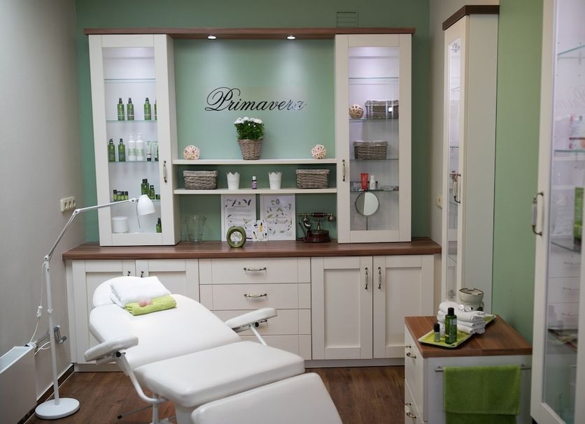 Hotel Golfi in Poděbrady spa treatment room with massage chair, cabinet, and product displays