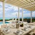 Sailrock South Caicos dining terrace with infinity pool and turquoise ocean view in Cockburn Harbour