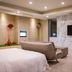 Ohya Chain Boutique Motel Taoyuan room with bed, sofa, wall-mounted TV and marble accent wall in Taoyuan City