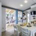 Vela Blu Camping Village in Cavallino Treporti, bright kitchenette and dining area opening to a patio