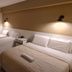 Faixa Hotel in Vitória da Conquista guest room with two beds, bedside lights, and TV