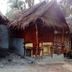 Relax Beach House in Ko Lanta: thatched beachfront bungalow with small porch seating and wooden railing