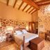 Agroturismo Es Quatre Cantons room in Binissalem with stone walls, wood beams and a double bed