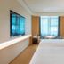 Ji Hotel Guiyang Fountain guest room with two beds, large TV, and city view in Guiyang