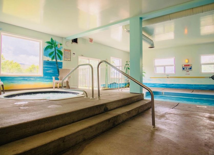 Country View Motor Inn in Kamloops: indoor pool with hot tub and painted palm-tree mural