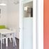 Del Garda Village and Camping in Peschiera del Garda: bright dining nook with green sofa and white table