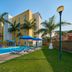 Pool area at City Express by Marriott Lazaro Cardenas in Lazaro Cardenas with palm trees and loungers