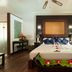 Le Relax Beach Resort, Grand'Anse Praslin: flower-decorated bed in a bright room with balcony doors