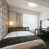 APA Hotel Nagasaki Ekimae room with bed, desk, mirror, and frosted glass shower door