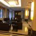Shell House Hotel in Baoding lobby lounge with dark sofas, low tables, and tall windows