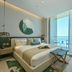 Onyx Rotana in Manama guest room with sea-view balcony, king bed and modern seating