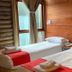 Hosteria Posta de los Colonos room with two single beds and wood-paneled walls in Villa La Angostura