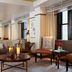 Westhouse Hotel New York lounge with sofa, armchair, coffee table and city windows in New York