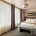 The Flat Iron Hotel, Asheville guest room with king bed, floor-to-ceiling windows and modern seating