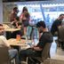 Guests dining in The Unicontinental - Campus Accommodation café in Mumbai with seating near bright windows