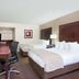 Baymont by Wyndham Sandusky guest room with two beds, desk, chair, lamp and TV