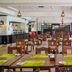 Mombasa Continental Resort in Mombasa restaurant with wooden tables, green placemats and pendant lights