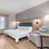 Candlewood Suites Houston (The Woodlands) by IHG guest room with bed, desk, TV and armchair