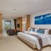 Kudo Hotel & Beach Club (Adults Only) Patong guest room with king bed, sofa, and ocean view