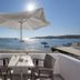 Irene Hotel - Beachfront in Parikia: seaside terrace table with umbrella overlooking calm bay and boats