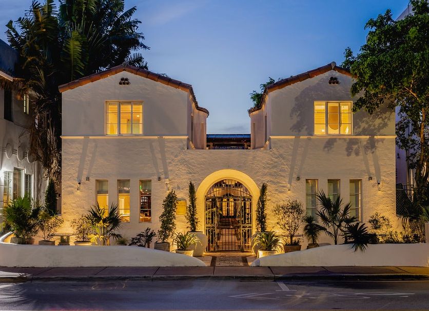 Donatella Boutique Hotel in Miami Beach exterior at dusk with lit entrance and palm trees