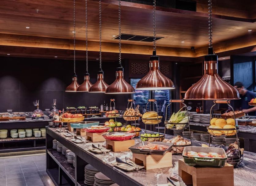 Nysa Hotel Bangkok Sukhumvit 11 breakfast buffet with hanging copper lights in Bangkok