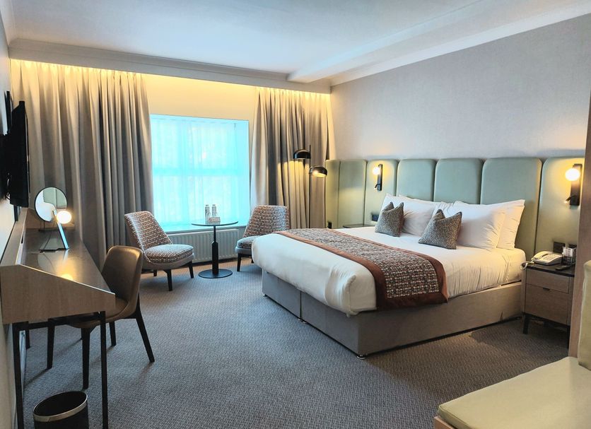 Menlo Park Hotel Galway guest room with king bed, seating area and large window