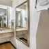 Red Roof Inn Tinton Falls-Jersey Shore bathroom vanity with sink, mirror, and wall-mounted hair dryer in Tinton Falls