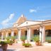 Club Hotel Marina Beach in Orosei courtyard with terracotta pots, arches, and blue railings