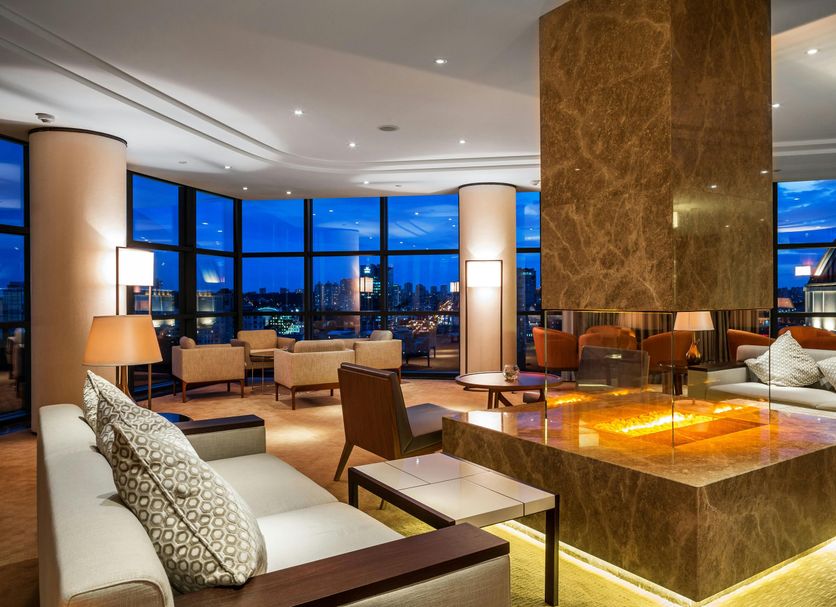 Hilton Kyiv lounge with central fire feature, city views, and floor-to-ceiling windows in Kyiv